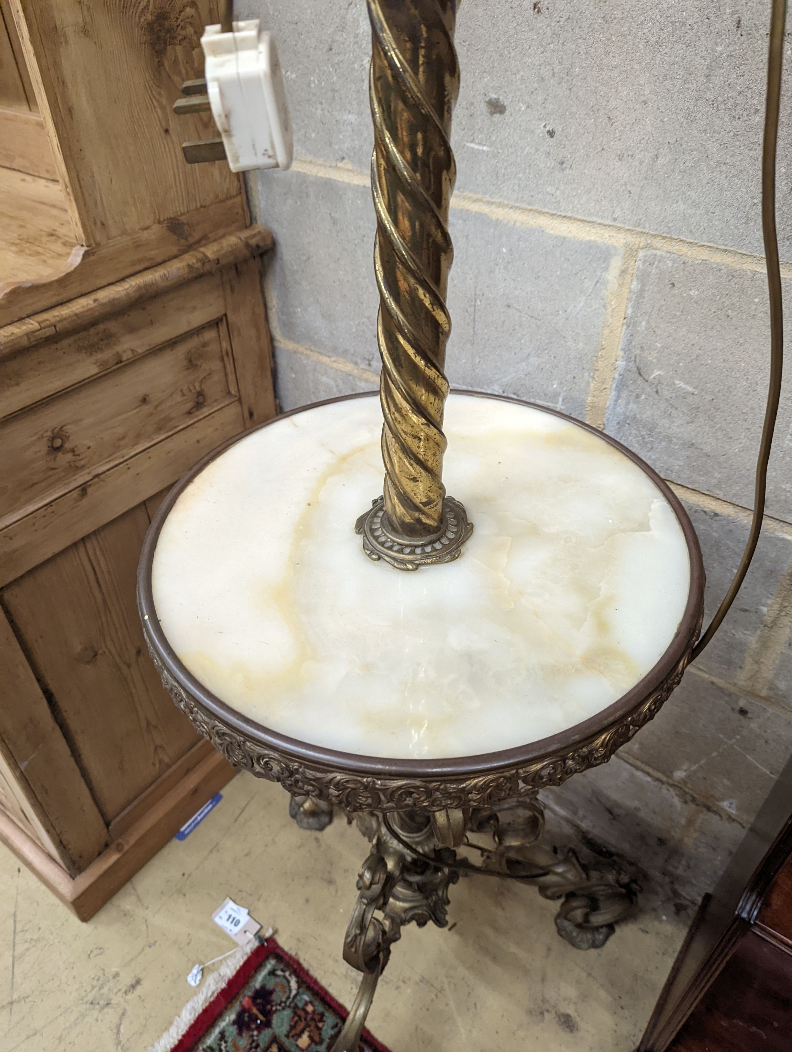 A late Victorian cast brass and onyx oil lamp standard, the column with an alabaster mid tier, raised on an open scrolled tripod base, converted to electricity, height 152cm